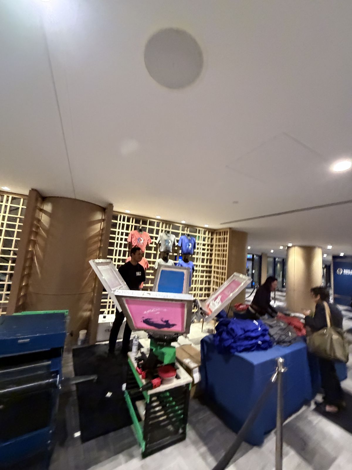 Guests watching custom merch get printed live at a Memphis event